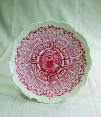 William Gilbert Grace. Original Coalport porcelain plate commemorating W.G. Grace's Century Of Centuries 1895, decorated in the rarer puce (red) with central portrait of Grace and dates of each individual century and who scored against radiating out from 