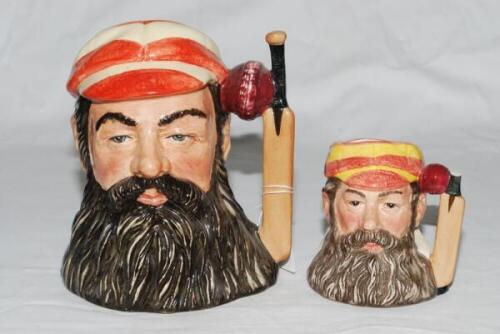 W.G. Grace. Large Royal Doulton ceramic caricature toby jug of W.G. Grace wearing M.C.C. cap, with cricket bat and ball handle. Approx 7" tall. 1996. Good condition. Sold with a similar but smaller Royal Doulton ceramic caricature toby jug of 'The Champio