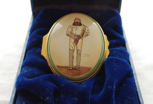 'W.G. Grace'. Halcyon Days oval enamelled pill box. The lid decorated with full length figure of Grace by 'Spy', biographical details of Grace to the inside of the lid, the inside base with inscription, 'W.G. Grace, 1848-1915. Hero of English Cricket'. St