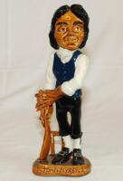 John Nyren- Cricketer Tutor. Ceramic caricature figure of Nyren in cricket attire holding bat with name to ceramic base. The figure stands 11" tall. Produced by The Hambledon Trading Company (John Brindley) c1990's. G - cricket