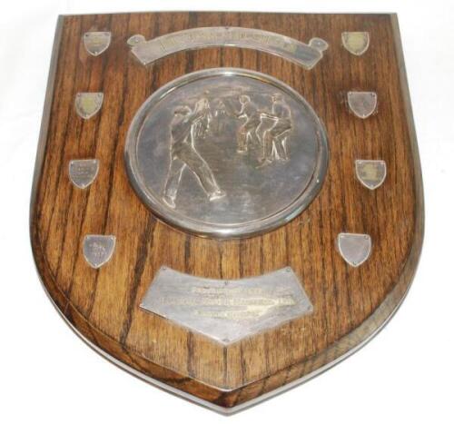 'The Oakland Shield'. Large wooden shield presented for annual winners, being departments within the company of Marshall, Kaye & Marshall Ltd'. To centre is a large circular silver plate [?] image of a cricket match in progress with title in scroll to top