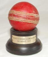 Gloucestershire v Lancashire 1989. Original red cricket ball used in the County Championship match played at Nevill Road on the 8th August 1989. This was the final day of the match. The ball mounted on small wooden plinth with metal plaque below with matc