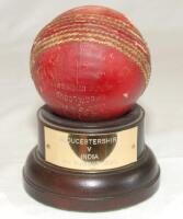 Gloucestershire v India 1990. Original red cricket ball used in the tour match played at Bristol on the 4th August 1990. This was the opening day of the match. The ball mounted on small wooden plinth with metal plaque below with match details. Formerly th