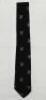 John Richard Reid. Otago, Wellington & New Zealand 1947-1965. Official New Zealand silk tie with silver ferns and 'NZCC XI' emblems on black background, issued to Reid for the 1965 tour to England. The tie by 'Eskay' of Wellington with Reid's name in ink 