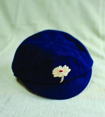 Yorkshire navy blue 1st XI cap. Early navy blue cap, with the Yorkshire white rose emblem to the front. The cap, with smaller peak, typical of a pre first world war cap, by E.C. Devereux of Eton. The stem of the rose emblem in white rather than the later 