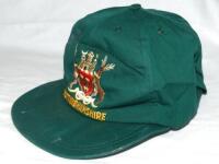 Mark Saxelby. Nottinghamshire, Durham & Derbyshire. Green baseball style Nottinghamshire Sunday First XI cap worn by Saxelby, with signed note of authentication. Sold with one long sleeve and one short sleeve Nottinghamshire 2nd XI woollen sweaters worn b