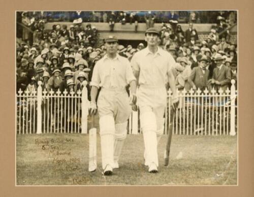 M.C.C. tour to Australia 1928/29. Original sepia press photograph of Jack Hobbs and Douglas Jardine walking out to open the innings in the fifth Test at Melbourne, 8th-16th March 1929 (timeless Test). Hand written description 'from Bob to Ralph' to lower 