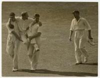 Don Bradman 1938. Original mono press photograph of Bradman being carried off the field at The Oval having injured his foot in the fifth Test. Date stamp to verso, 23rd August 1938. Central Press Photos, London. 9.5"x7.25". G/VG - cricket - cricket