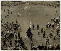 The Ashes. England v Australia, 5th Test, The Oval 1953. Excellent original large mono press photograph taken from high in the pavilion at The Oval, depicting the Australians sprinting off the field at the conclusion of the final Test, England having won 