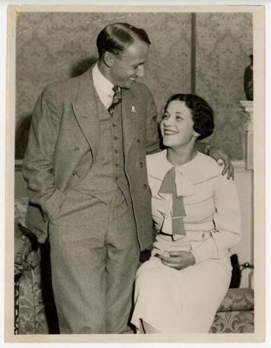 Don Bradman 1934. Two large iconic original mono press photographs of Bradman with his wife, Jessie, both taken at Dover in 1934, Jessie having just arrived to be reunited with her husband, both wearing formal attire. One depicts the smiling couple with B