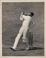 Frank Woolley. Kent & England 1906-1938. Excellent original mono press photograph of Woolley playing a lofted attacking shot to leg. The photograph partly laid to mount with handwritten caption in ink to verso, 'Frank Woolley hits Alf Gover out of the Ova