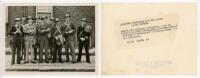 Middlesex wartime cricketers. Original mono photograph of nine members of the Middlesex team and staff standing smartly dressed wearing helmets, in their roles as members of the London Police Reserve. Players featured include Wignall, Hart, Harrington, D.