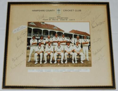 Hampshire C.C.C. County Champions 1973. Official colour photograph of the Championship winning team seated and standing in rows wearing cricket attire with the trophy. The photograph, measuring 10"x7.5", mounted with printed title to the mount which has b