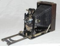 Photographic equipment. c.1912 Internationale Camera Aktiengesellschaft 'Toska 215' 9cm x 12cm vertical folding bed plate camera. Appears to be fitted with later Graflex f/6.8 90mm lens (serial no. 312184) lacking shutter. G