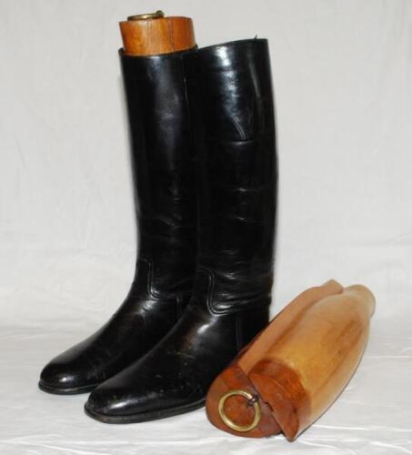 Horse riding boots. A pair of vintage black leather long riding boots with original wooden full length tree inserts with brass fittings to tops. Stamped to inside 'Style C2287. E2225. Size 8' and owner's name 'Harrison' inscribed in ink. Maker and date un