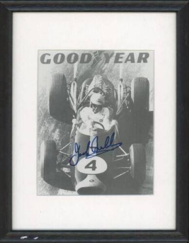 Motorsport. A Goodyear mono printed advertising card of Jack Brabham at the wheel, signed by Brabham. 5"x6". Mounted, framed and glazed, overall 7.5"x9.5". Sold with a colour photograph of John Surtees in race action, signed by Surtees. Framed and glazed,