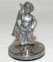 Golf car mascot c.1940s/1950s. Silver metal car bonnet mascot in the form of a boy caddy carrying a golf bag and clubs on his shoulder. 4.5" tall. Some tarnishing and wear, otherwise in good condition
