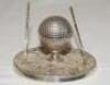 Golf ink stand. Attractive silver plated ink stand in the form of a hinged golf ball on tee with metal liner, two upright golf clubs to either side. James Dixon of Sheffield c.1930. 3" tall. G