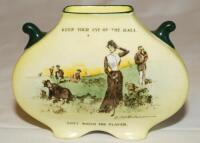 Small Royal Doulton spill[?] vase featuring a colour illustration to one side of a 'Gibson Girl' on a golf course, surrounded by golfers searching for their ball. Title above and below the image reads, 'Keep your eye on the ball. Don't watch the player'. 