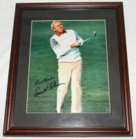 Arnold Palmer and Nick Faldo. Colour photograph of Palmer in action on the fairway, signed by Palmer. Framed and glazed, overall 11"x13". Also a colour photograph of Nick Faldo playing out of a bunker, signed by Faldo. Framed and glazed, 14.5"x12". Qty 2.