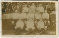 'Tottenham Hotspur Cup Team 1910'. Early mono real photograph postcard of the team and officials, standing and seated in rows on the pitch with the large crowd behind them, for the matches played at White Hart Lane, with printed title 'Tottenham Hotspur C