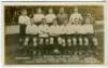 'Tottenham Hotspur Cup Team 1913'. Early mono real photograph postcard of the team and groundsman, standing and seated in rows on the pitch with the large crowd behind them, with printed title 'Spurs' Cup Team 1913' and players names printed to lower bord