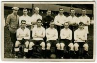 Tottenham Hotspur 'Cup Final Winning' team 1920/21. Early mono real photograph postcard of the team and the trainer standing and seated in rows in front of the Main Stand. Publisher unknown. Postally unused. Minor wear otherwise in good condition - footba