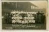 Tottenham Hotspur F.C. 1921/22. Mono real photograph postcard of the playing staff, directors and officials standing and seated in rows with English Cup and Charity Shield to centre, with title printed to lower border 'Tottenham Hotspur. F.C. 1921-22'. W.