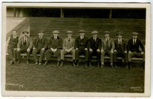 Tottenham Hotspur F.C. c1920/21. Original mono real photograph postcard of members of the team and officials? sitting in front of the West Stand in suits, flat caps and ties. W.J. Crawford of Lower Edmonton. Postally unused. Minor silvering to edges other