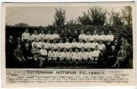 Tottenham Hotspur F.C. 1930/31. Mono real photograph postcard of the playing staff, officials and directors, standing and seated in rows, with title and players names to lower border. W.J. Crawford of Edmonton. Postally unused. Very good condition - footb