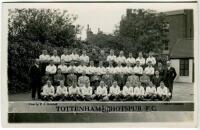 Tottenham Hotspur F.C. 1934/35. Mono real photograph postcard of the playing staff, officials and directors, standing and seated in rows, with title to lower border. W.J. Crawford of Edmonton. Postally unused. Good/very good condition - football