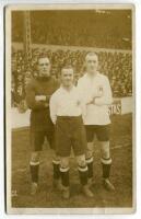 Tommy Clay, Fanny Walden and Bill Jaques. Tottenham Hotspur circa 1920-1922. Mono real photograph postcard showing all three players, full length on the pitch, in Spurs shirts, with large crowd behind them in the stand. W.J. Crawford of Edmonton. Minor fa