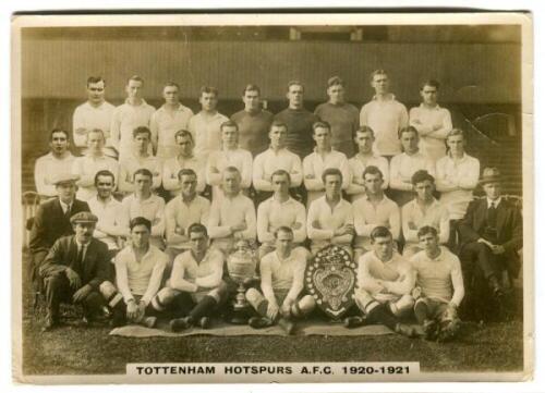 'Tottenham Hotspurs A.F.C. 1920-1921'. Phillips 'Pinnace' premium issue cabinet size sepia real photograph trade card of the playing staff, manager and trainers, standing and sitting in rows, in front of the stand displaying the English Cup and the Charit