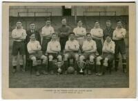 Tottenham Hotspur Junior Reserves 1944/45. Mono real photograph of the team, standing and seated in rows, displaying two trophies. Title to lower border 'Tottenham Jun. Res. Winners North London Alliance League Div 2 and London Minor Cup 1944-5'. Publishe