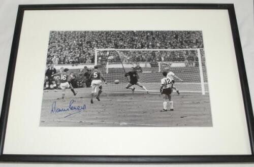 Tottenham Hotspur F.C. 1960s. Mono photograph of Martin Peters scoring for England against West Germany in the 1966 World Cup Final. Boldly signed in ink by Peters. Mounted, framed and glazed, overall 17"x13". Sold with a colour photograph of Alan Mullery