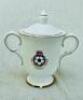 'Centenary of the Football League 1888-1988'. A Royal Doulton bone china two-handled cup and lid. Cup transfer printed with decoration of the famous painting by Thomas Hemy of Sunderland v Aston Villa in 1895 and Football League crest to the reverse. Cove