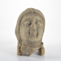 A Carved Stone Figure Head