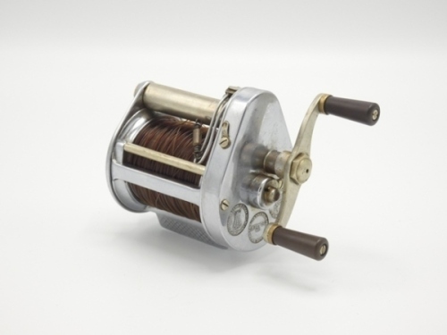 A Hardy Elarex bait casting reel, chromed casing, twin reverse tapered ebonite handles, level-line mechanism, two casting controls to rear plate, in original rexine case and a Hardy "No.2 LRH Spinning" 2 piece cane salmon spinning rod, 9'6", green/crimso