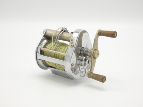 A Hardy Elarex bait casting reel, chromed casing, twin reverse tapered ebonite handles, level-line mechanism, two casting controls to rear plate and a Hardy "No.1 LRH Spinning" 2 piece cane salmon spinning rod green/crimson tipped wraps, green inter-whip
