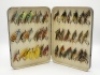 A good Malloch black japanned large rectangular salmon fly box, the cream painted interior fitted bars of nickel silver spring clips and holding a good selection of 36 fully dressed large salmon irons, mainly 7/0 and 6/0 sizes, lid with applied oval nick - 2