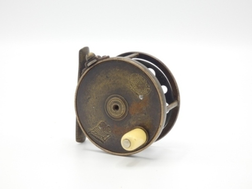 A rare Hardy 1896 Brass Perfect 2 ½" trout fly reel, domed ivorine handle, pierced block foot, triple drum pillars, strapped rim tension screw with Turk's head locking nut and early calliper spring check mechanism, open ball race with steel bearings, dru
