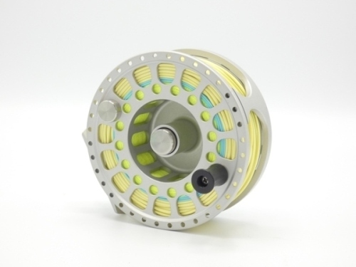 A Shilton SL7 salmon/saltwater fly reel and spare spool, silver graphite finish, counter-balanced handle, ventilated large arbour drum, , rear spindle mounted milled drag adjuster, only light use, in original nylon pouch with drag oil bottle