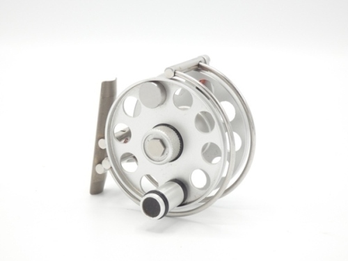A good Ari't Hart Remco trout fly reel, right hand wind model, brushed alloy finish, counter-balanced handle, milled spool locking nut, three quarter wire line guide, off-set foot on "L" shaped stancheon (shortened), rear spindle mounted tension adjuster