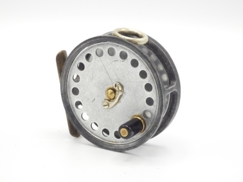 A Hardy No.3 Pattern Trade 3" trout fly reel, unleaded drum with single band of perforations, ebonite handles and nickel silver telephone drum latch, white metal line guide, milled brass rim tension screw and Mk.II check mechanism, interior stamped "T.A.