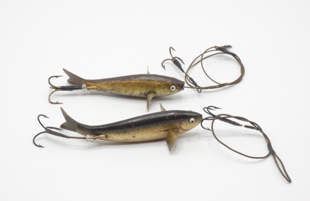 A scarce Allcock Caledonian 3 ½ gutta percha bait, the curved fish shaped  lure naturalistically painted and with white/black spot glass eyes, twin  metal spinning vanes and tail, central brass hollow spindle