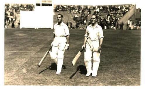 Herbert Sutcliffe and Percy Holmes, Yorkshire. Original mono real photograph postcard of Holmes and Sutcliffe walking out to bat at Scarborough. Match unknown but early 1930s. The photograph by Walkers Studios with additional stamp for C.J. Withnell &amp;