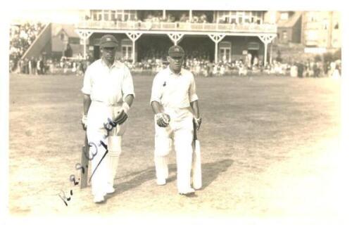 Robert Elliott Storey Wyatt. Warwickshire, Worcestershire &amp; England 1923-1951. Nice original mono real photograph postcard of Wyatt walking out to bat at Scarborough wearing his England cap, with Patsy Hendren wearing a Middlesex cap. Nicely signed in