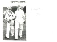 R.E.S. Wyatt and David Townsend. Scarborough 1935. Nice original mono real photograph plain back postcard of Wyatt walking out to bat at Scarborough with David Townsend (Oxford University &amp; England 1933-1935), both wearing England caps. The match is a