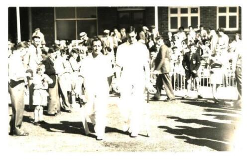 Peter May and Bill Edrich. Original mono real photograph plain back postcard of May and Edrich walking out to bat at Scarborough. Match unknown but probably c.1951. Photographer unknown. VG - cricket