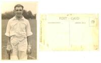 Leslie Ethelbert George 'Les' Ames. Kent &amp; England 1926-1951. Sepia real photograph postcard of a youthful Ames standing three quarter length leaning on his bat at the wicket. Nicely signed in ink to the photograph by Ames. Flemons of Tonbridge. Adhes